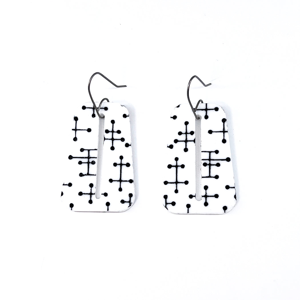 White trapezoid Pin Dot etched acrylic earrings on white background.
